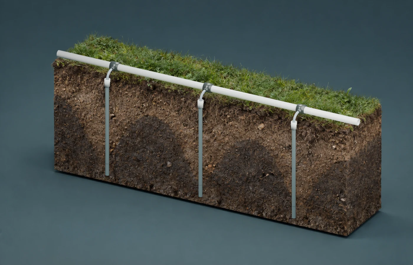 Continuous soil section with saturated ground shown as darker damp earth below a conceptual water table that dips toward each intake.